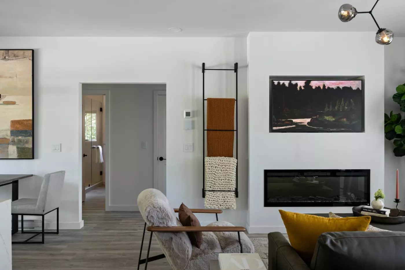 Modern living room featuring art, a fireplace, and cozy seating.