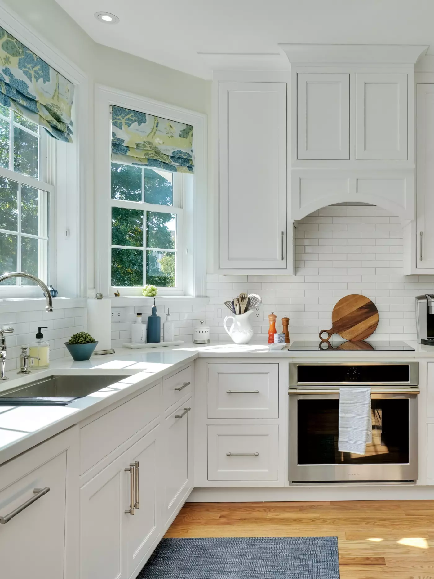 Modern kitchen with white cabinetry, a large island, and cozy seating.