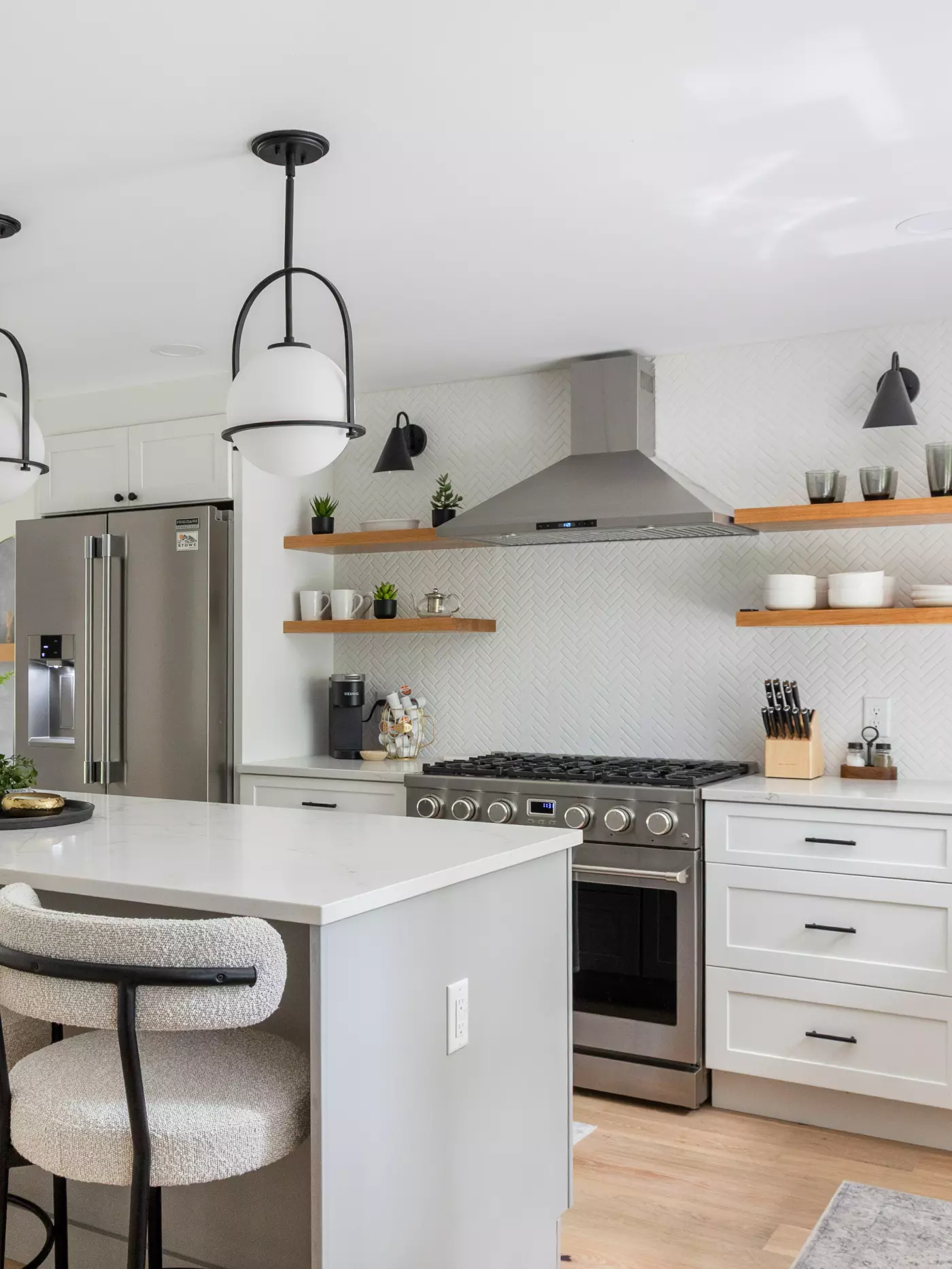 Modern kitchen featuring a gas stove, open shelves, and stylish pendant lighting.