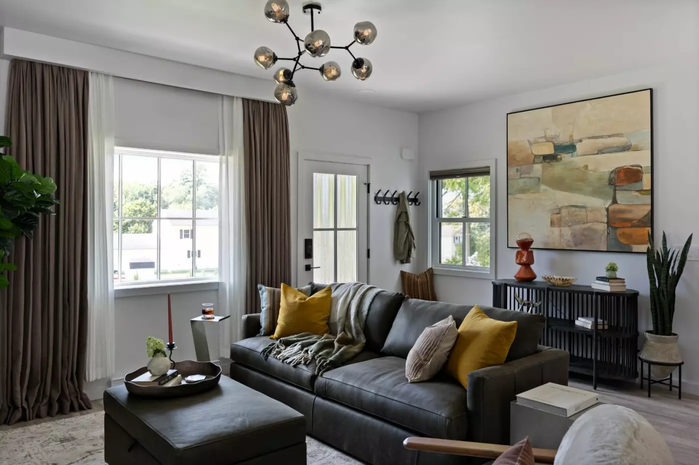 Cozy living room featuring a leather sofa, artwork, and modern decor.