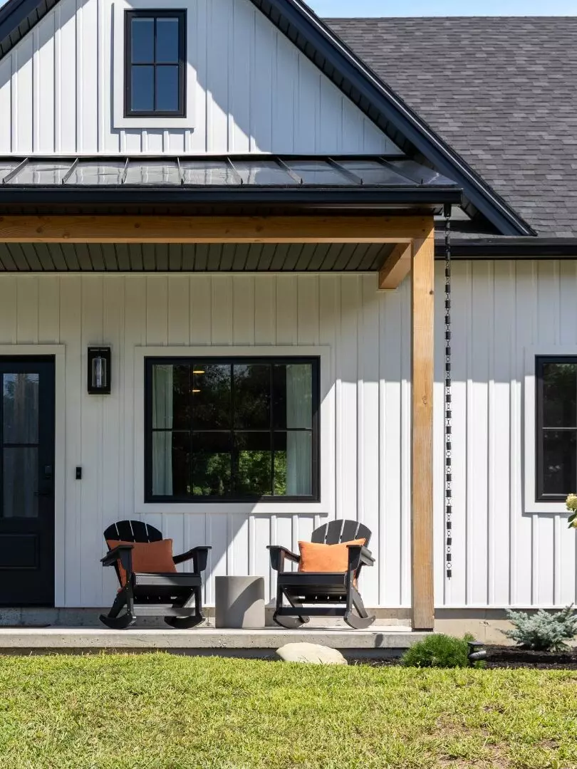 Front porch featuring two rocking chairs and a modern farmhouse design.