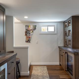 Cozy home bar area featuring a map wall art and wine storage.